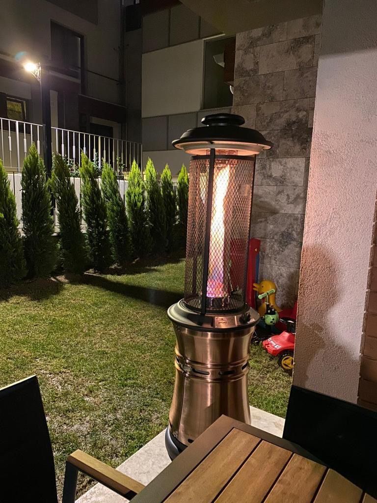 Gece bahçede çalışan bakır gövdeli fener soba